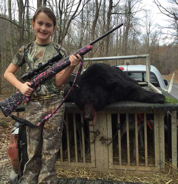 Trinity with her first bear kill. She's been  bear hunting with her father since she was four years old. She was so proud. 