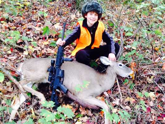 Austin, 10, with his first deer, taken with a .223 Smith Wesson MP Sport