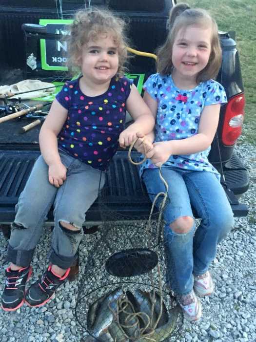 This is Jessalyn, age 3, and her sister, Lexie, age 5. They caught their daily limit of trout at Miller's Fork Pond in Wayne County, West Virginia