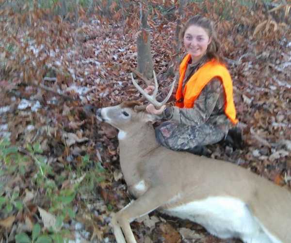 Sixteen-year-old Victoria with her eight point buck she killed in Braxton County.